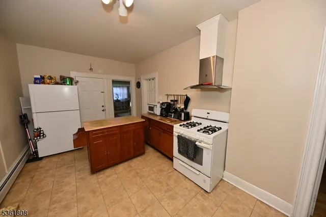a kitchen with stainless steel appliances granite countertop a stove a refrigerator and a microwave