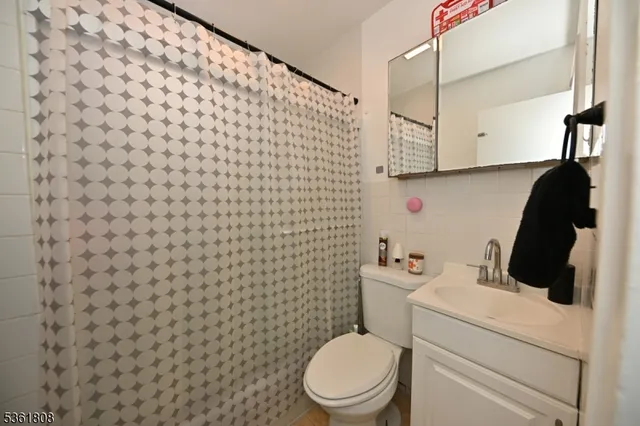 a bathroom with a toilet and a shower curtain