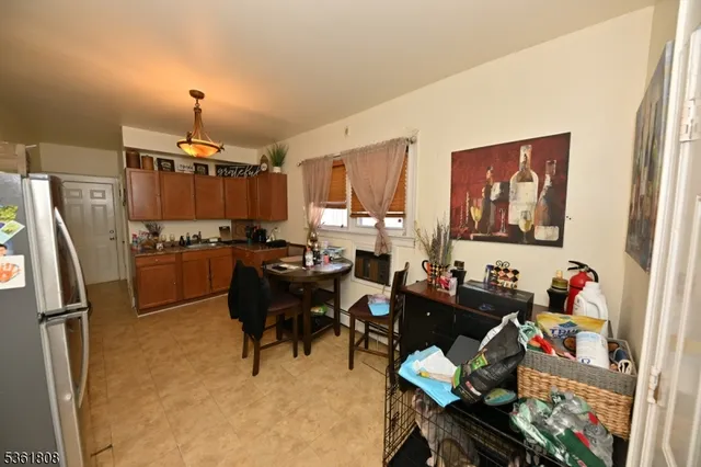 a kitchen with a refrigerator and a dining table