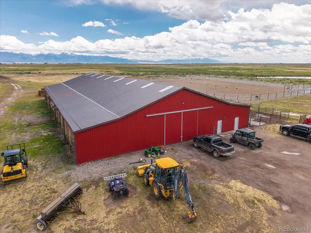 a view of a terrace with lawn chairs
