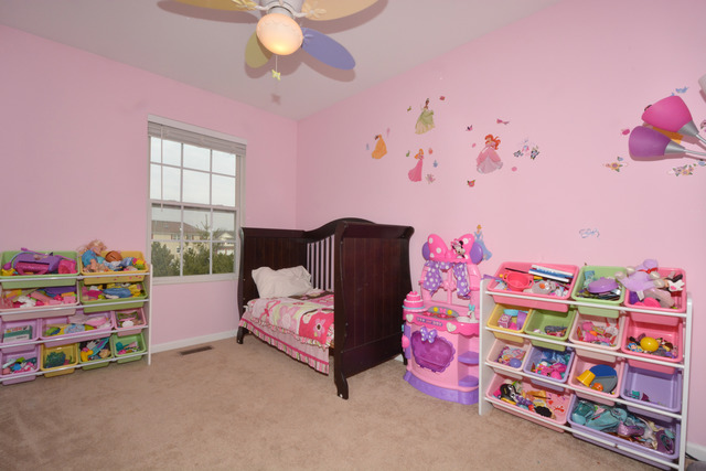 285 South Oak Creek Lane, Unit 285 Romeoville, IL 60446 - Photo 15 of 24 a bedroom with furniture and a baby crib