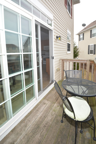 285 South Oak Creek Lane, Unit 285 Romeoville, IL 60446 - Photo 6 of 24 a view of a house with backyard and sitting area