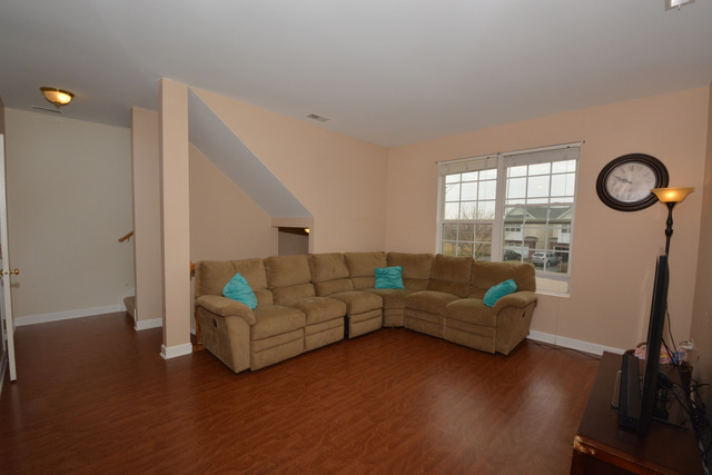 285 South Oak Creek Lane, Unit 285 Romeoville, IL 60446 - Photo 7 of 24 a living room with furniture and a large window