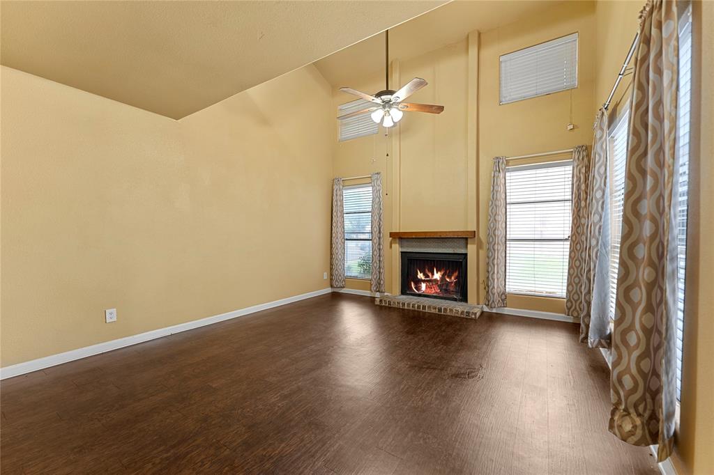 5516 Boca Raton Boulevard, Unit 310 Fort Worth, TX 76112 - Photo 2 of 19 a view of an empty room with a fireplace and a window
