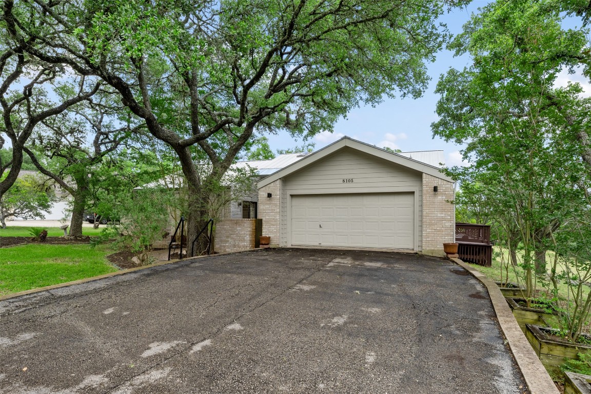 a view of a house with a tree and a yard