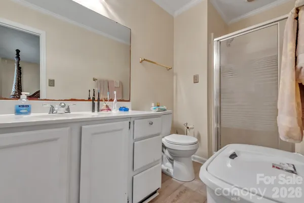 a bathroom with a tub sink toilet and mirror