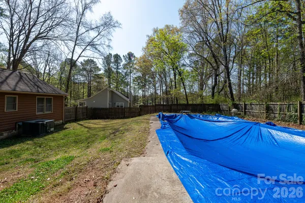 a view of backyard with trampoline