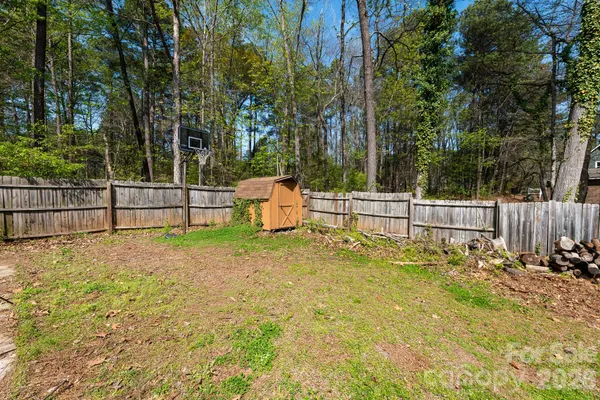 a view of a backyard with fence