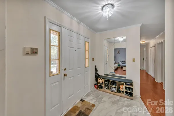 a living room with furniture and a dining table
