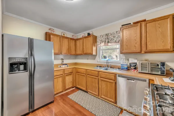 a kitchen with stainless steel appliances granite countertop a refrigerator sink and cabinets