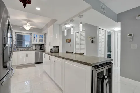 a kitchen with stainless steel appliances granite countertop a refrigerator and a stove top oven