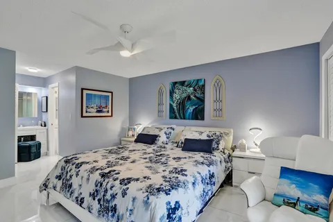 a bedroom with a bed and a chair