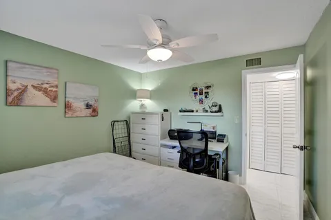 a bedroom with furniture and a large window