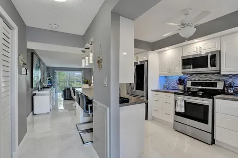 a kitchen with cabinets stainless steel appliances and a sink