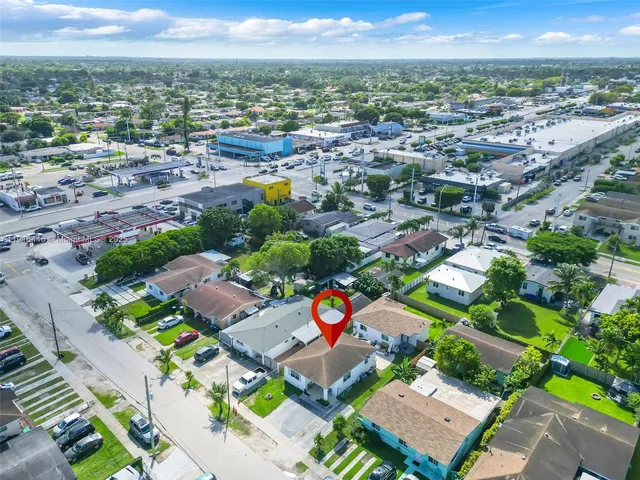 an aerial view of residential houses with outdoor space