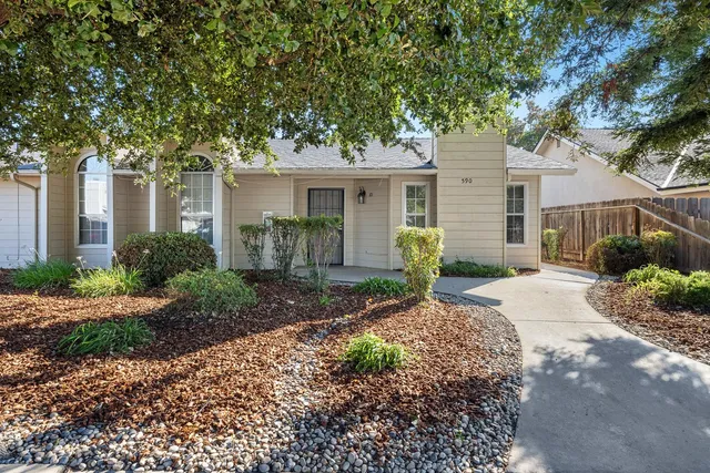 a front view of a house with garden