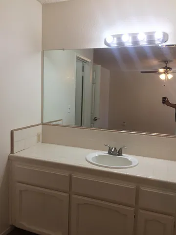 an aerial view of a house with a yard and large trees