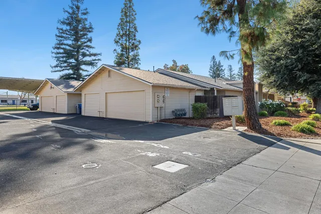 a view of a house with a yard and garage