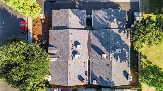 an aerial view of a houses with a yard