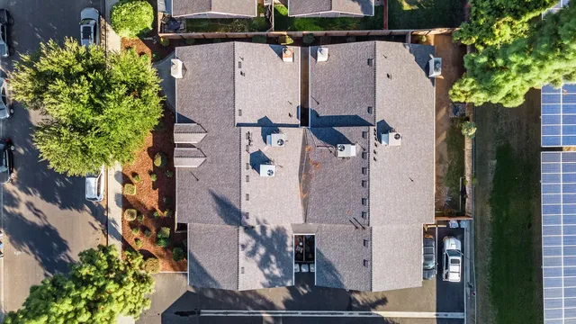 an aerial view of residential houses with outdoor space