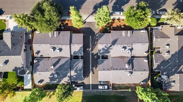an aerial view of a residential apartment building with a yard