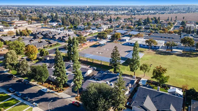 a kitchen with a sink a refrigerator and cabinets