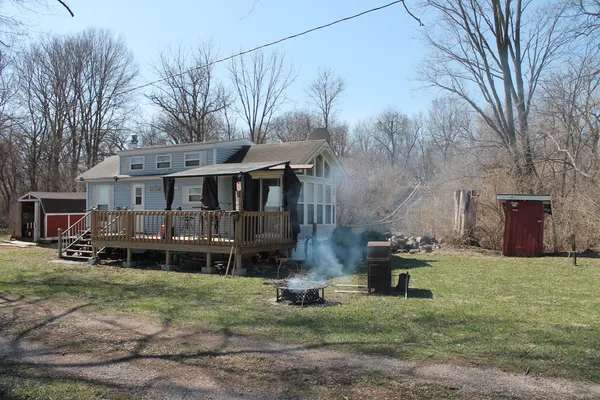 a backyard of a house with table and chairs