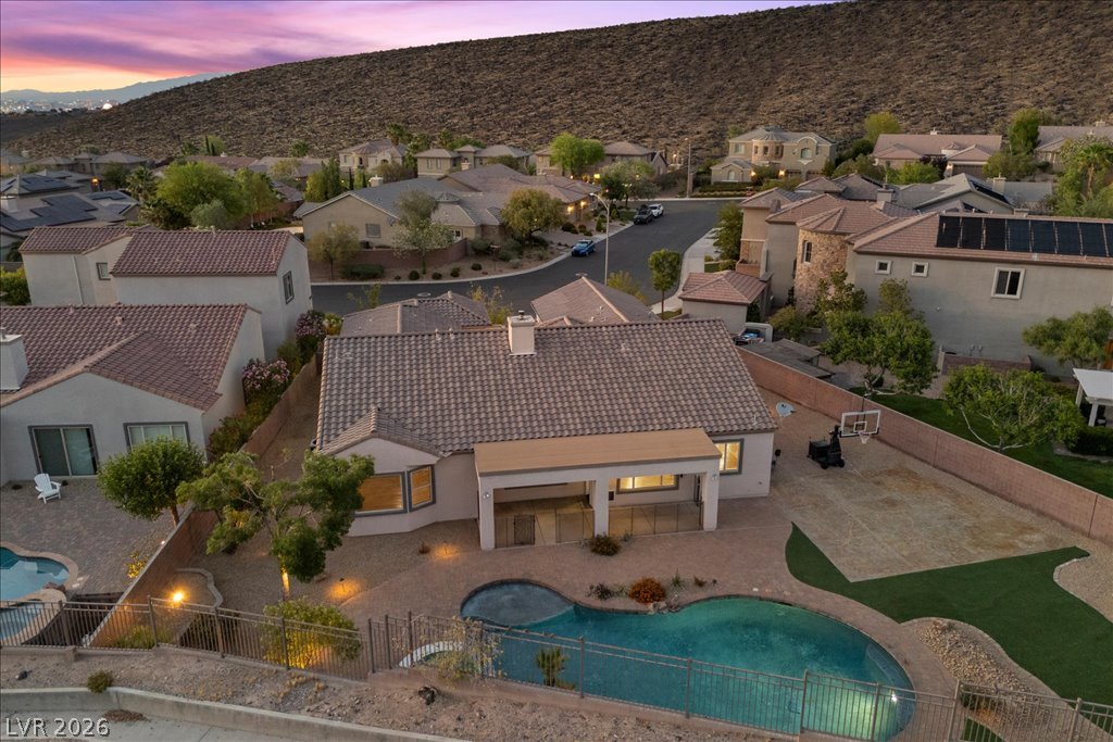 2125 De Rouge Avenue Henderson, NV 89044 - Photo 95 of 96 Backyard oasis with a refreshing pool, expansive patio, and distant hill views.