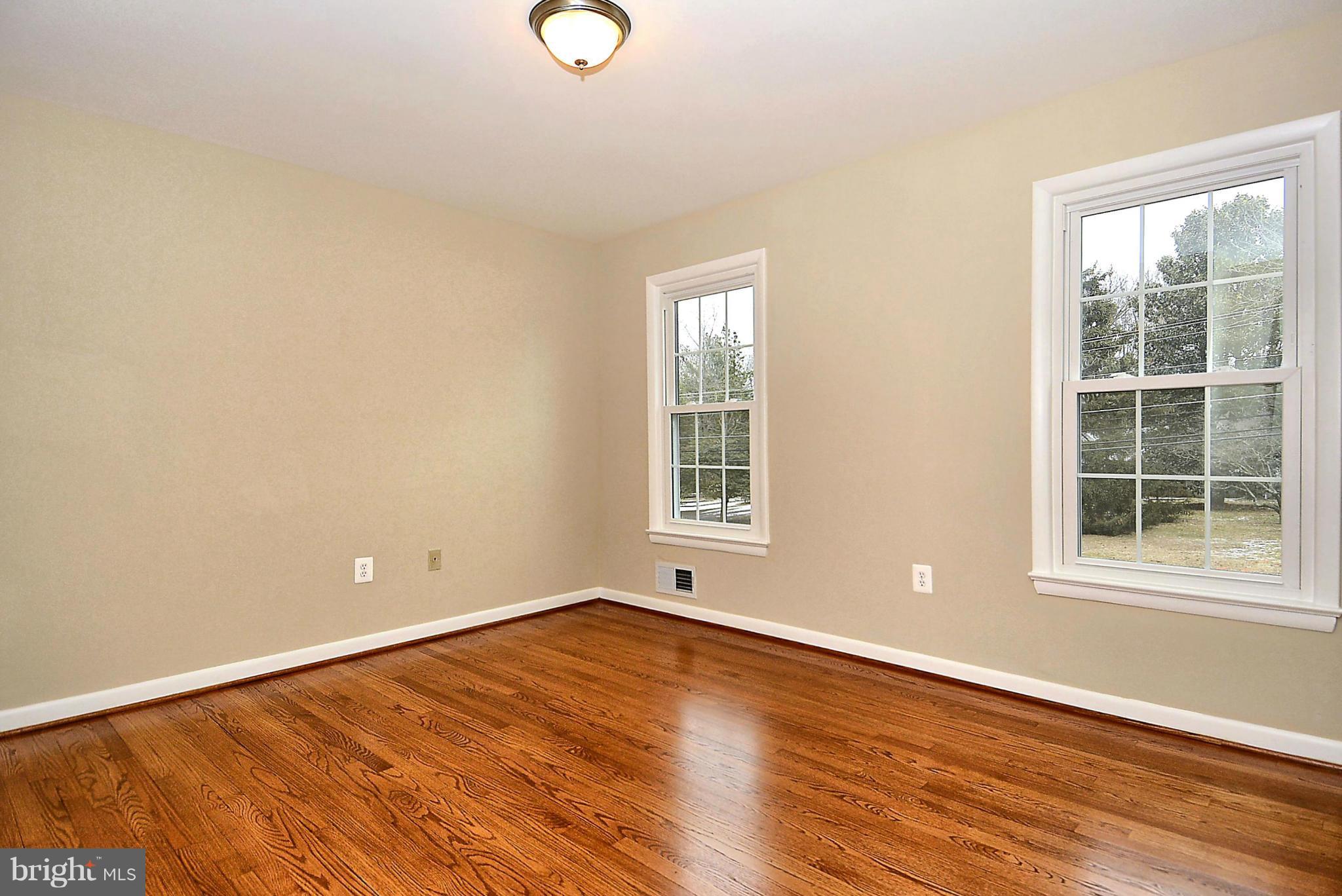 1870 Beulah Road Vienna, VA 22182 - Photo 14 of 30 an empty room with wooden floor and windows