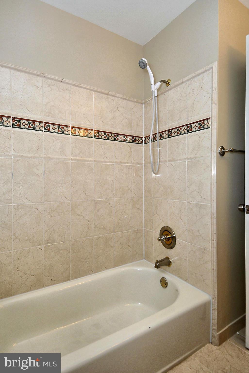 1870 Beulah Road Vienna, VA 22182 - Photo 16 of 30 a bathroom with a shower and a bathtub