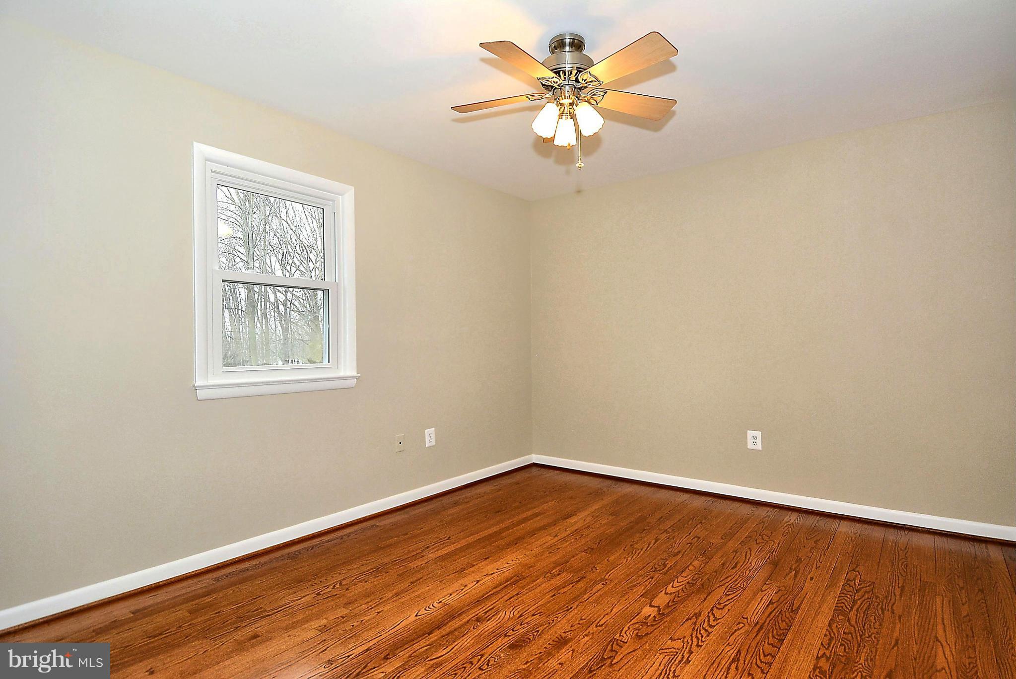 1870 Beulah Road Vienna, VA 22182 - Photo 17 of 30 a view of an empty room with a window and a ceiling fan