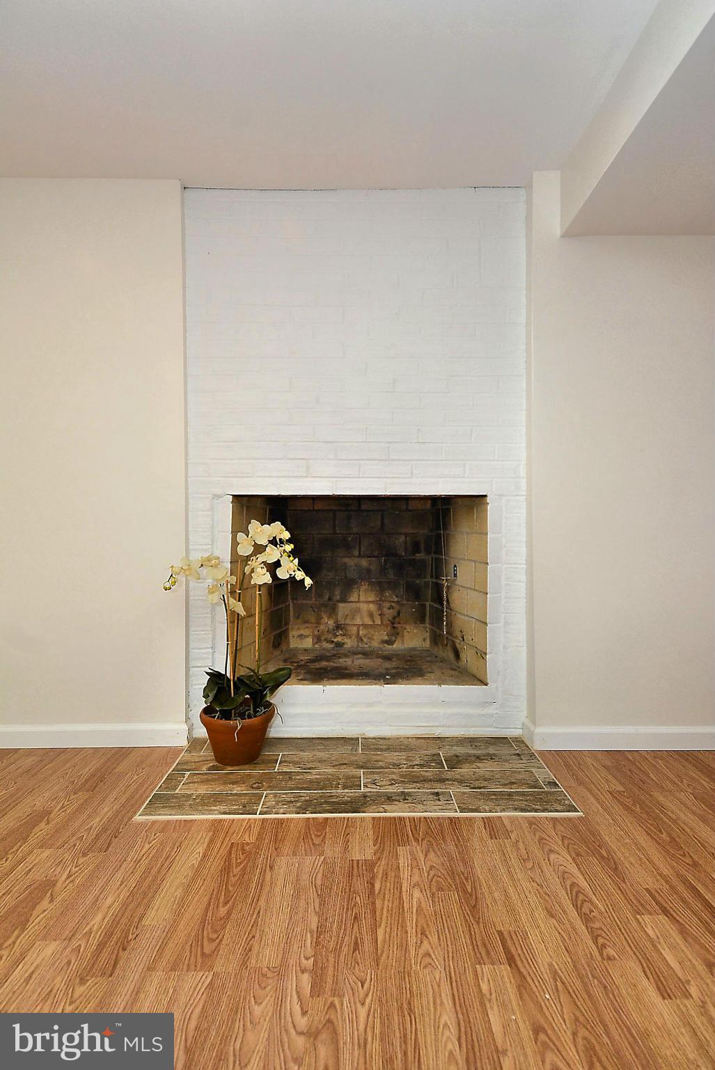 1870 Beulah Road Vienna, VA 22182 - Photo 20 of 30 a view of a livingroom with wooden floor and a fireplace