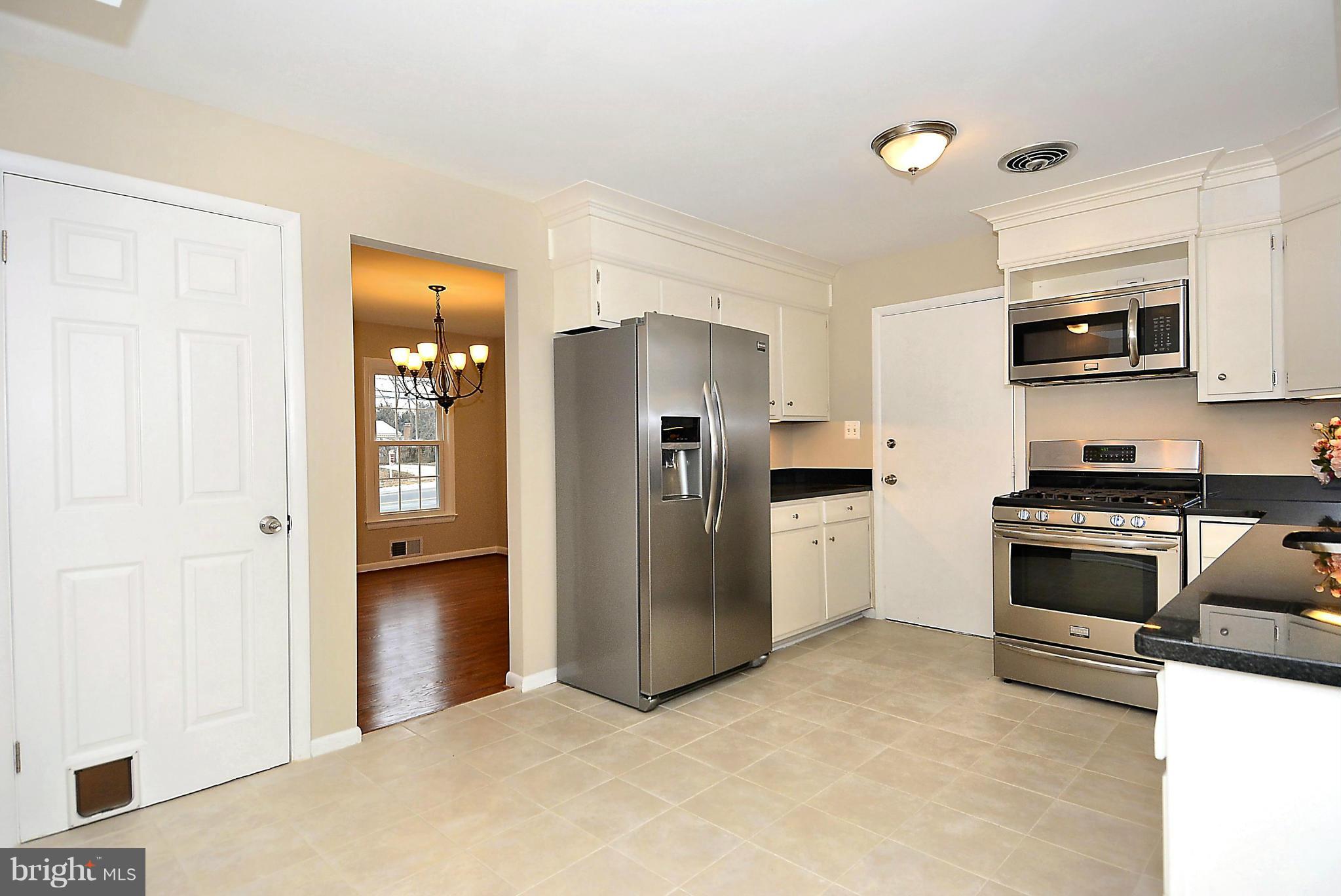 1870 Beulah Road Vienna, VA 22182 - Photo 6 of 30 a kitchen with stainless steel appliances a refrigerator and a stove top oven