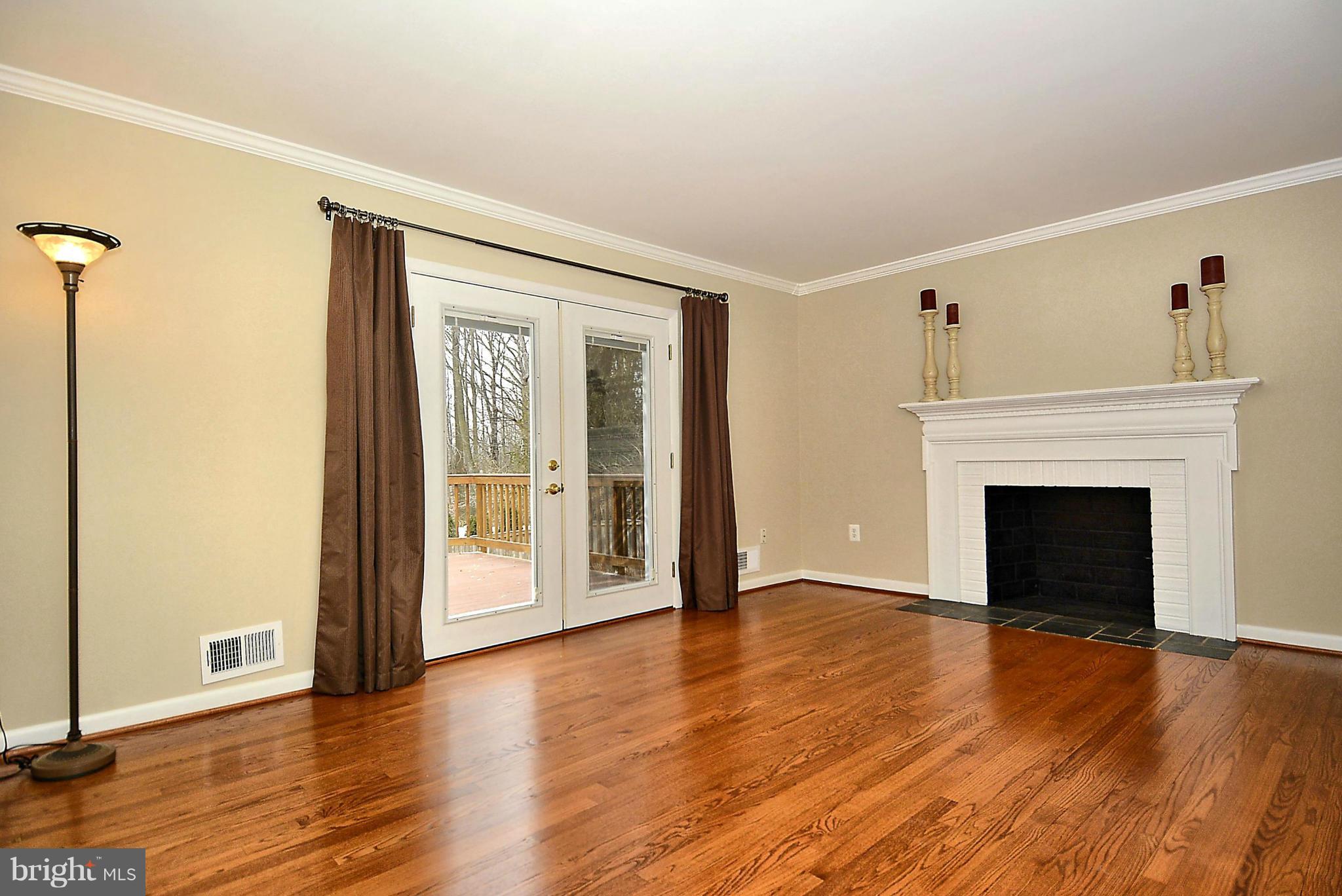 1870 Beulah Road Vienna, VA 22182 - Photo 7 of 30 a view of a livingroom with wooden floor and a fireplace