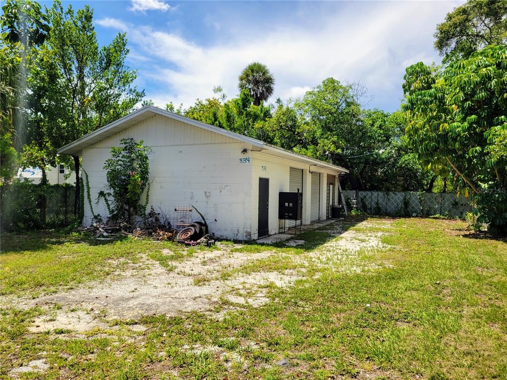 31st Ave Street North St. Petersburg, FL 33704 - Photo 1 of 8 a view of a house with a yard and garage