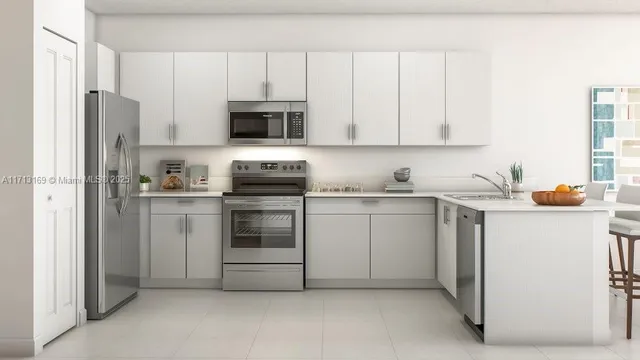 a kitchen with stainless steel appliances white cabinets and a refrigerator