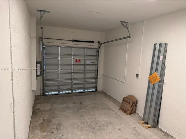 a view of empty room with wooden floor and cabinet