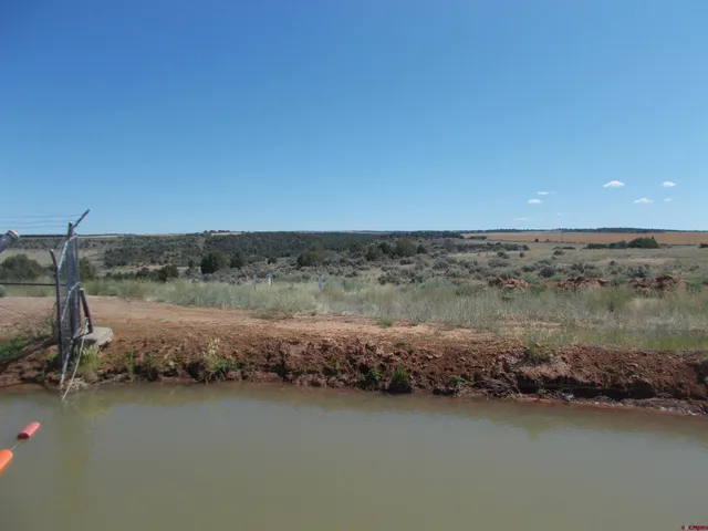 an aerial view of a house with a lake view