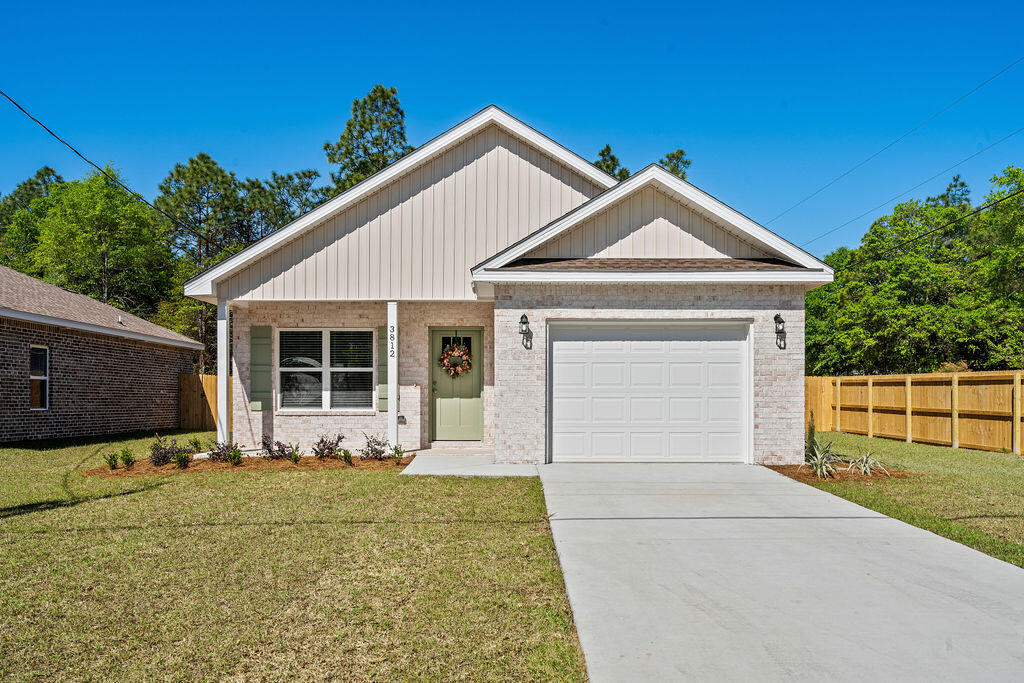 3812 Golden Acres Circle Crestview, FL 32539 - Photo 1 of 10 a front view of a house with garden