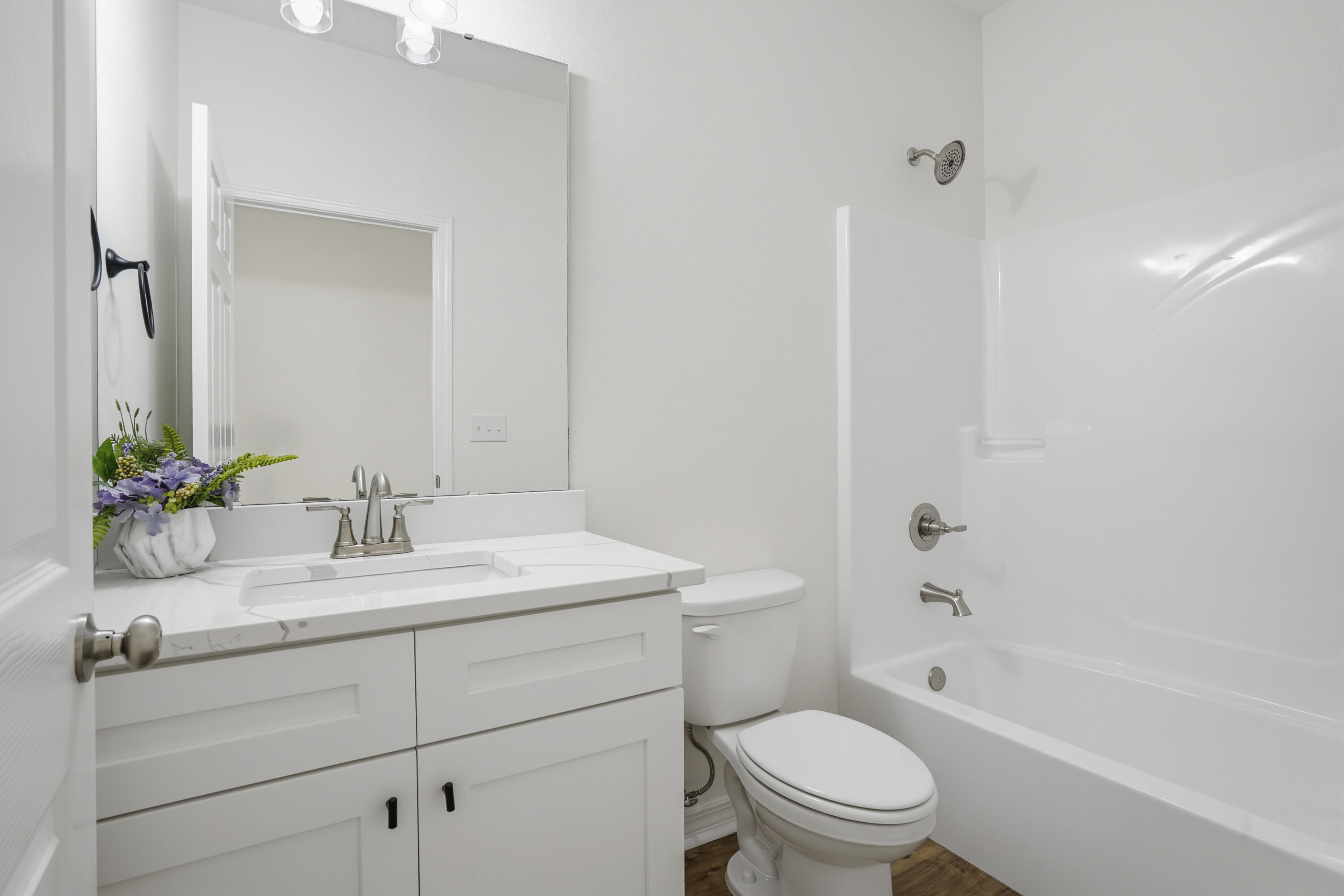 3812 Golden Acres Circle Crestview, FL 32539 - Photo 9 of 10 a bathroom with a granite countertop toilet a sink a mirror a bathtub and vanity