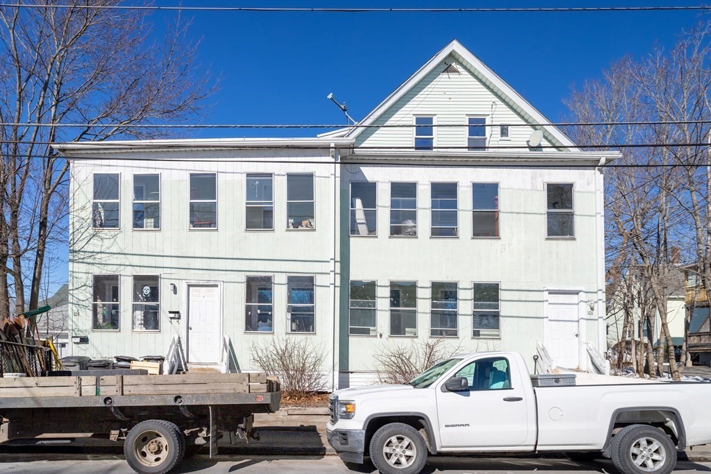 a front view of a building with parking space