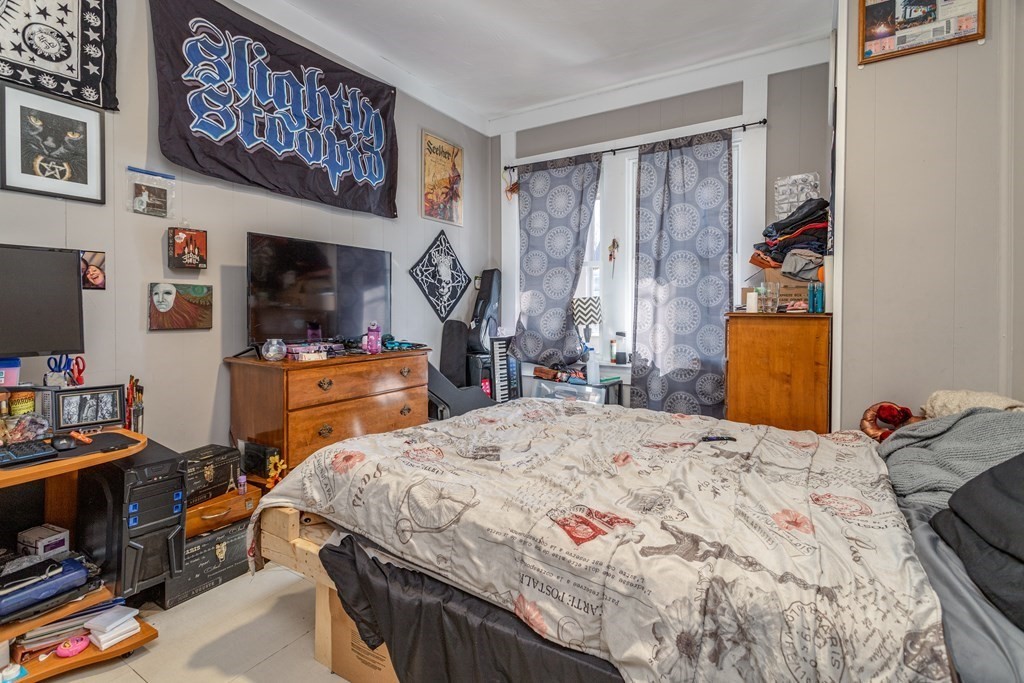 101-105 Baker Street Gardner, MA 01440 - Photo 13 of 37 a bedroom that has a bed and a tv in it