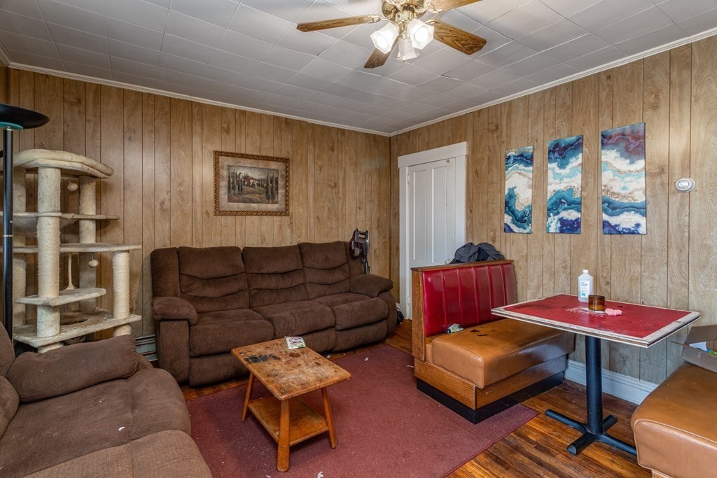101-105 Baker Street Gardner, MA 01440 - Photo 17 of 37 a living room with furniture and a chandelier