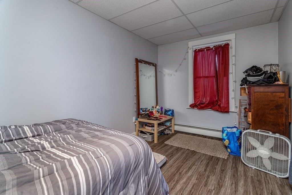 101-105 Baker Street Gardner, MA 01440 - Photo 23 of 37 a bedroom with a bed and a chair