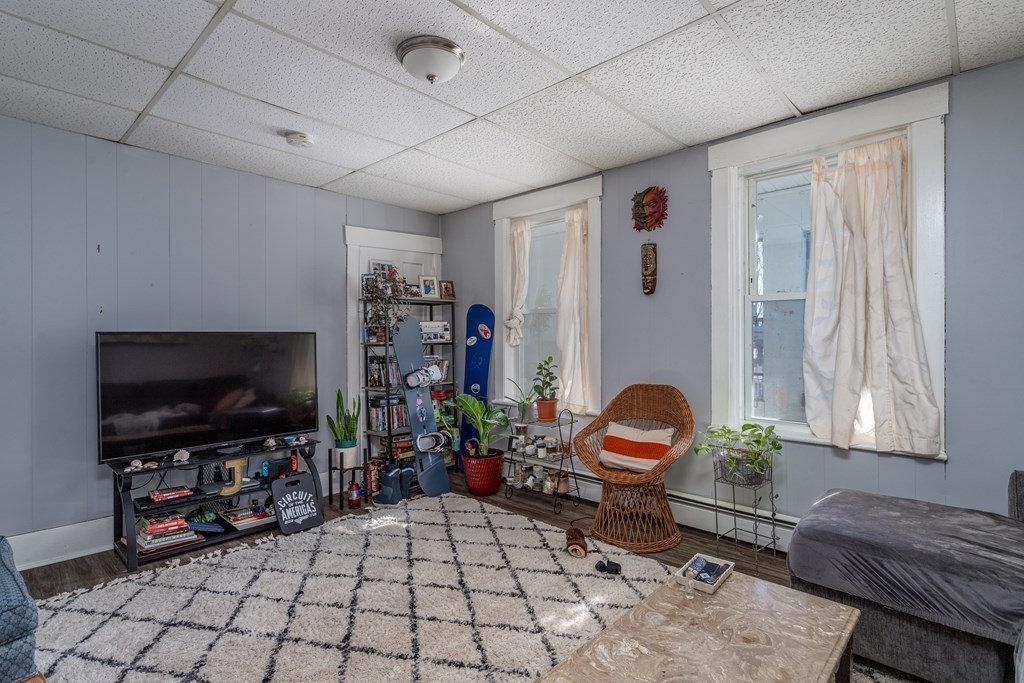 101-105 Baker Street Gardner, MA 01440 - Photo 29 of 37 a living room with furniture and a flat screen tv