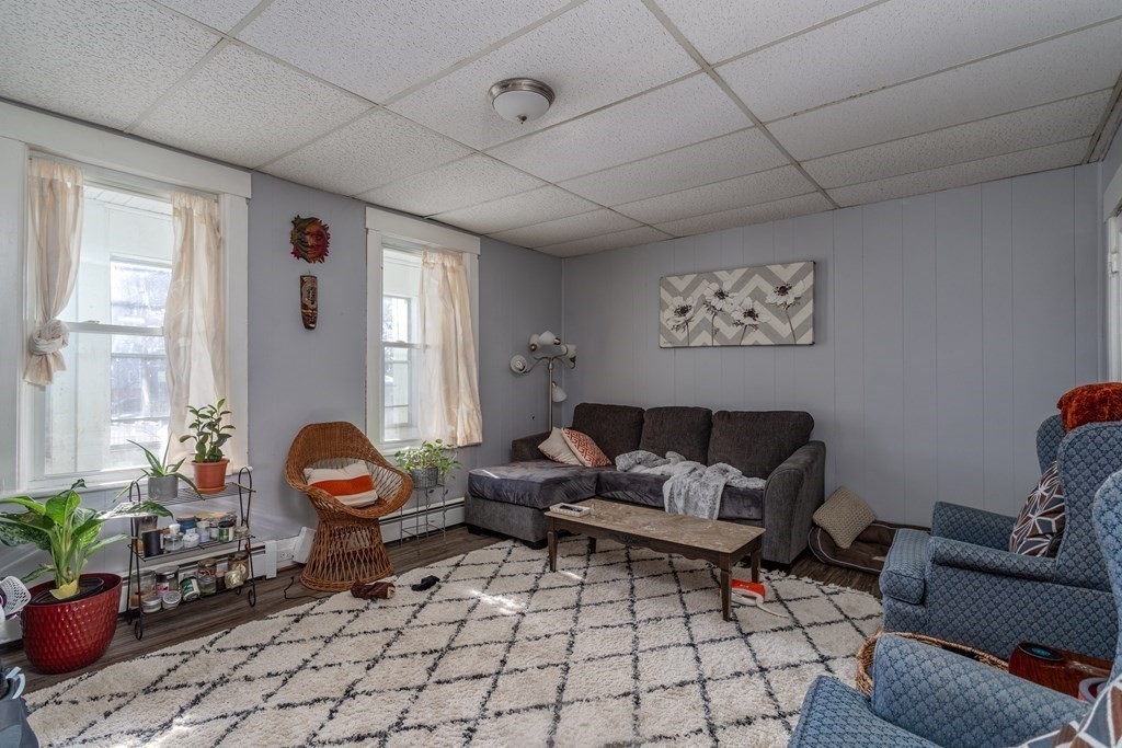 101-105 Baker Street Gardner, MA 01440 - Photo 32 of 37 a living room with furniture a rug and a window