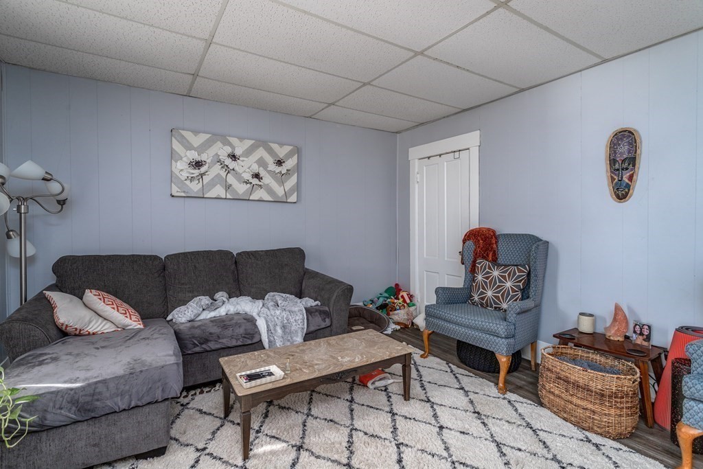 101-105 Baker Street Gardner, MA 01440 - Photo 33 of 37 a living room with furniture and a window