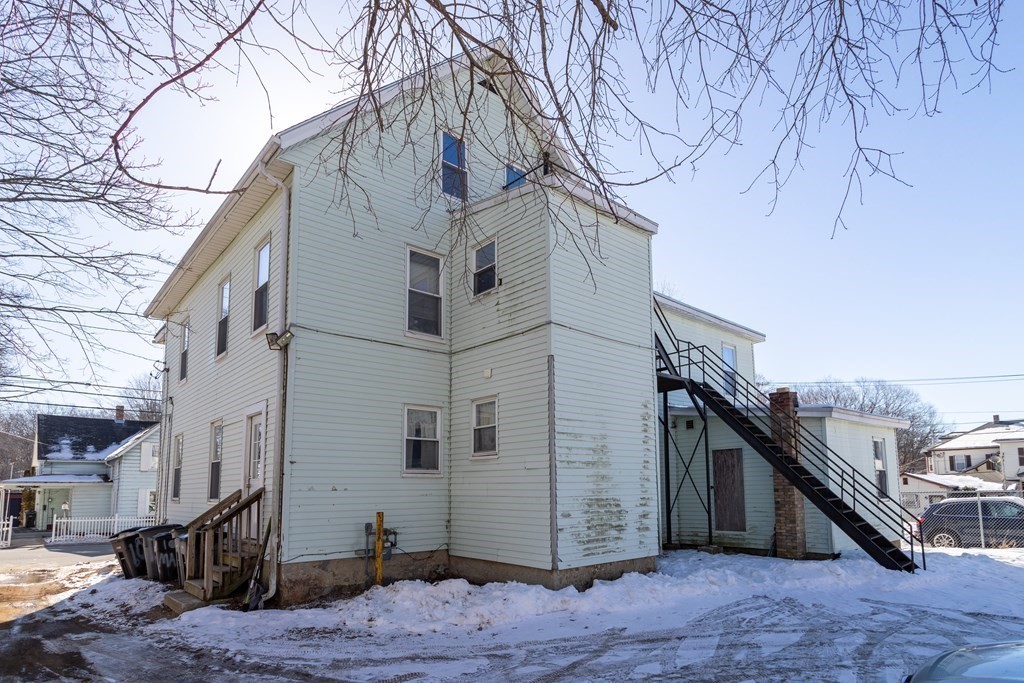 101-105 Baker Street Gardner, MA 01440 - Photo 4 of 37 a view of a white house with a large tree