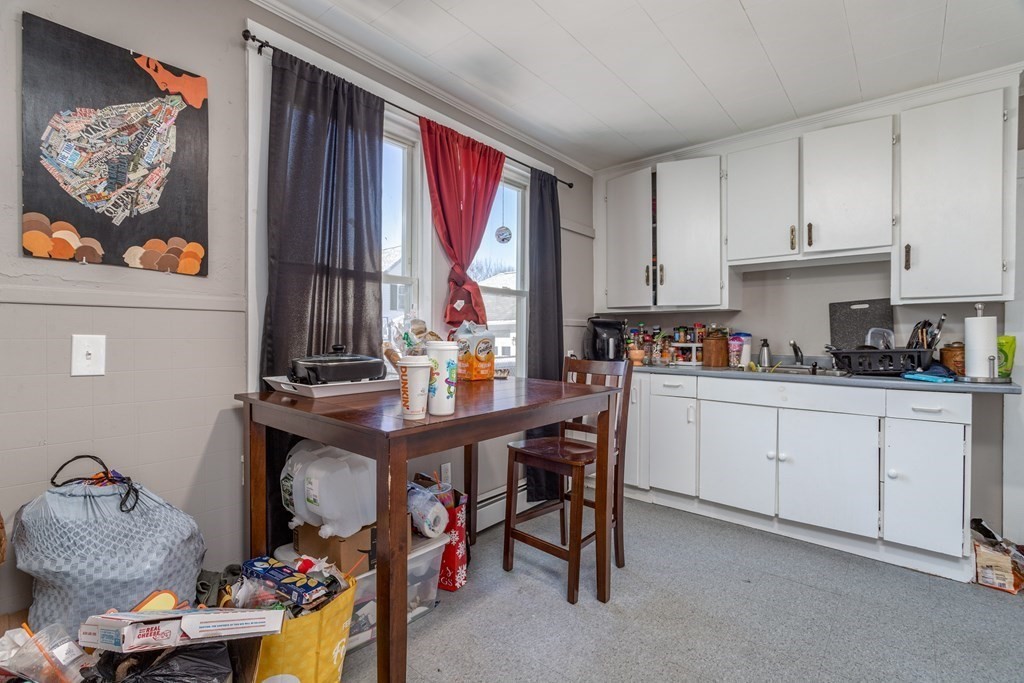 101-105 Baker Street Gardner, MA 01440 - Photo 7 of 37 a kitchen with stainless steel appliances granite countertop a sink dishwasher and cabinets with wooden floor
