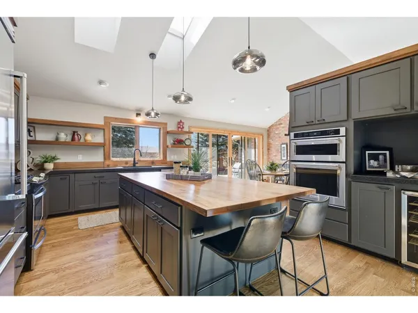 a kitchen with stainless steel appliances kitchen island granite countertop a sink and cabinets